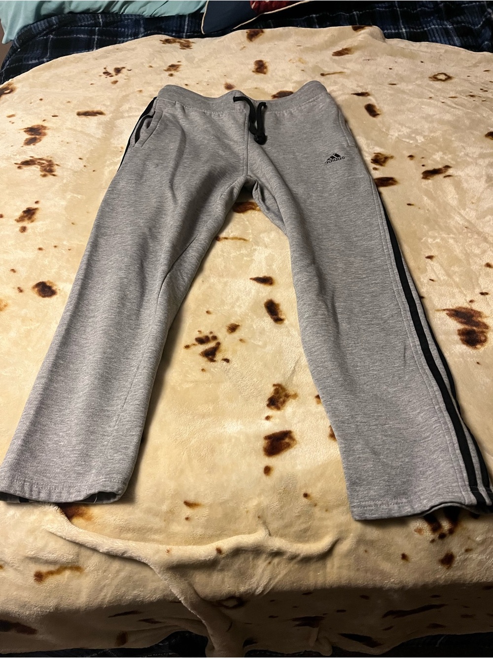 Adidas Gray Jogger Pants with Black Side Stripes.